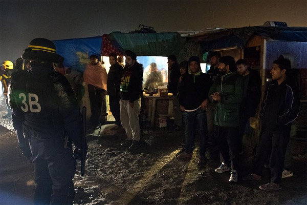Workers wield sledgehammers to tear down Calais 'Jungle'