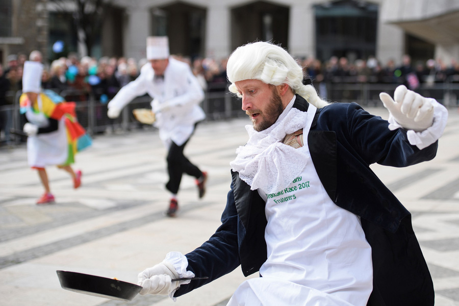In costume, Londoners flip pancakes in annual race