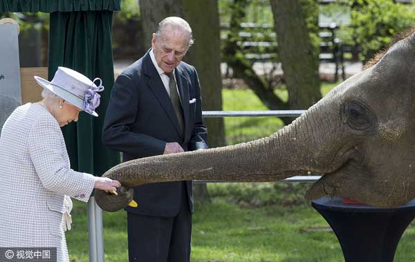 Queen Elizabeth II plays with her namesake baby elephant