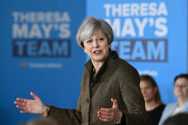 UK PM May reaffirms aim to bring down net immigration to 'tens of thousands' per year