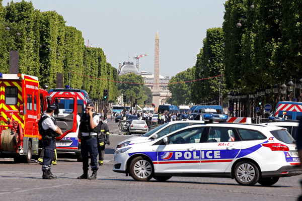 Car rams police vehicle on famed Paris avenue; attacker dies