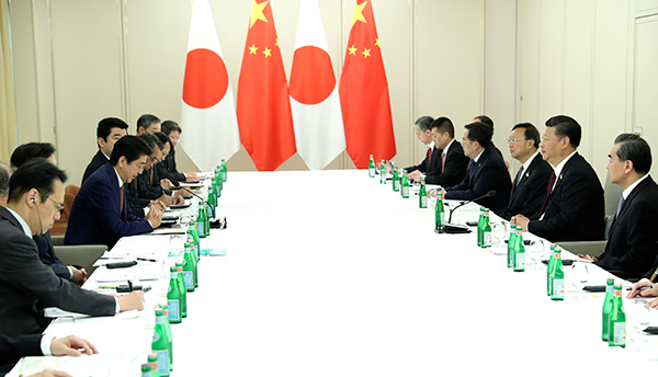 Xi meets Abe, urges Japan to honor words