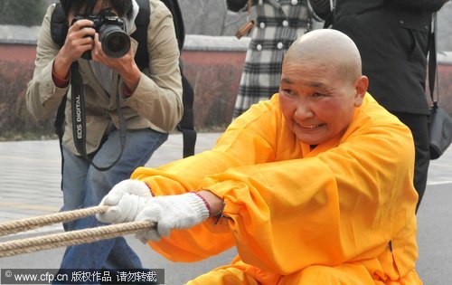 Buddhist nun shows off her strength pulling cars