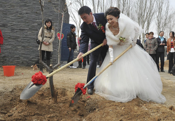 Newlyweds plant love trees on Arbor Day