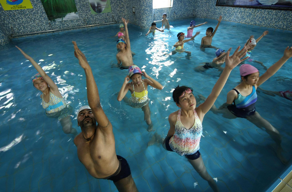 Practising yoga in swimming pool