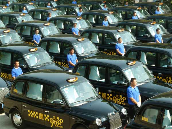 Classic British taxi cabs on road in E China