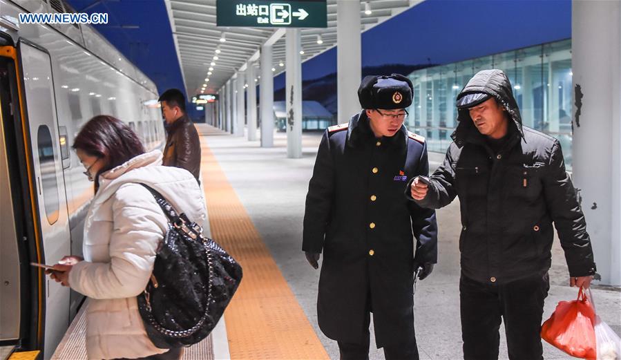 Young couple as railway workers busy for Spring Festival travel rush