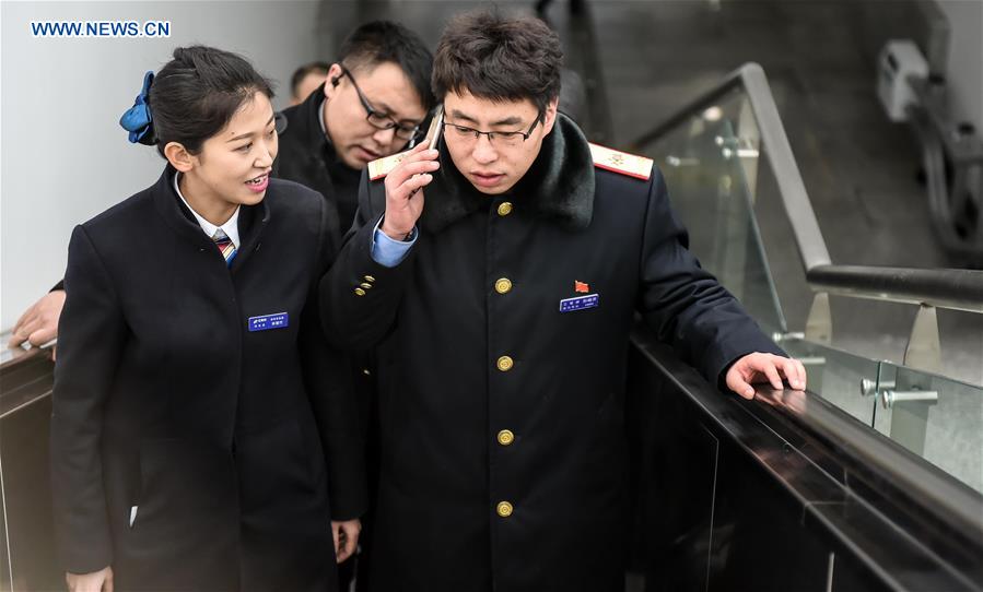 Young couple as railway workers busy for Spring Festival travel rush