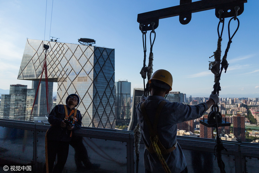 Workers behind Beijing's tallest building