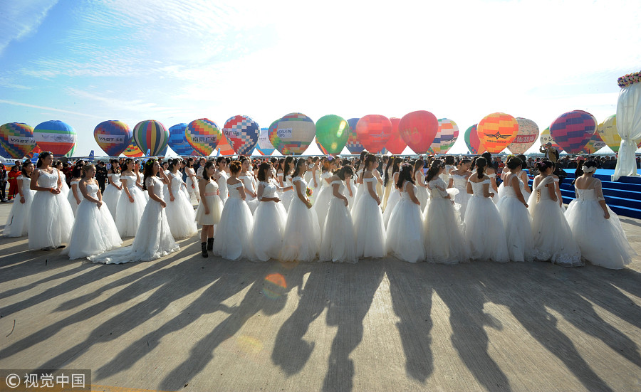 100 couples exchange vows in the air