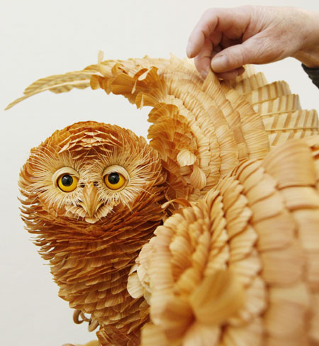 A life-sized owl sculpture made from cutting chips