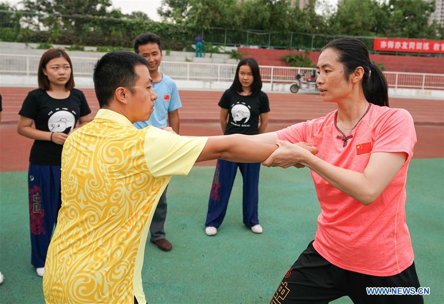 Wushu master practises boxing of Huo with her students in Tianjin