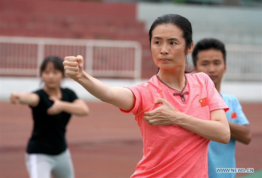 Wushu master practises boxing of Huo with her students in Tianjin