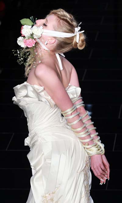 Models present creations during Sao Paulo Fashion week Summer 2012