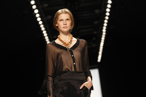 Models present creation at Berlin Fashion Week Spring/Summer 2012