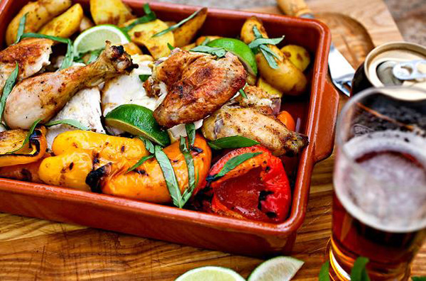 Spice-rubbed beer-can chicken with potatoes and sweet peppers