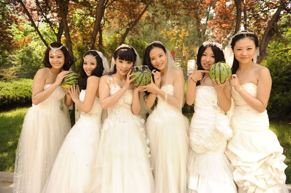 Graduates in wedding gowns honor college years