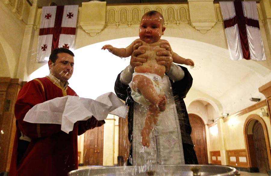 Babies baptised during a mass ceremony