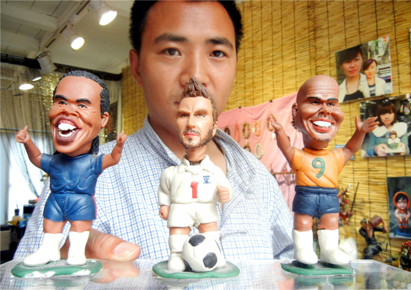 Artist creates dough figurine football stars