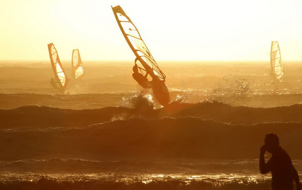 Windsurfers taking on waves in Cape Town