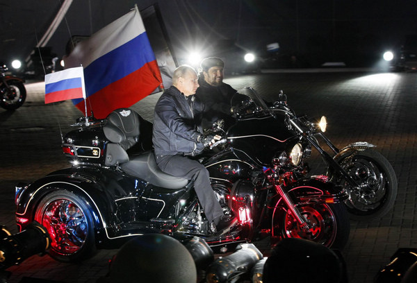 Putin rides with 'Night Wolves' at bike festival