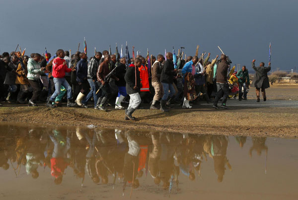 S. African miners march outside Marikana mine