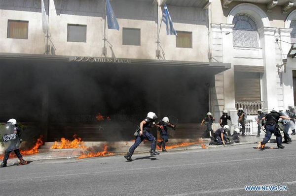 Protestors clash with anti-riot policemen in Athens