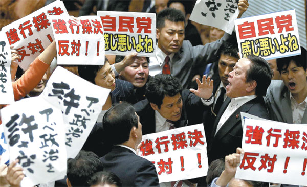 Japan's ruling bloc rams through controversial war bills in lower house