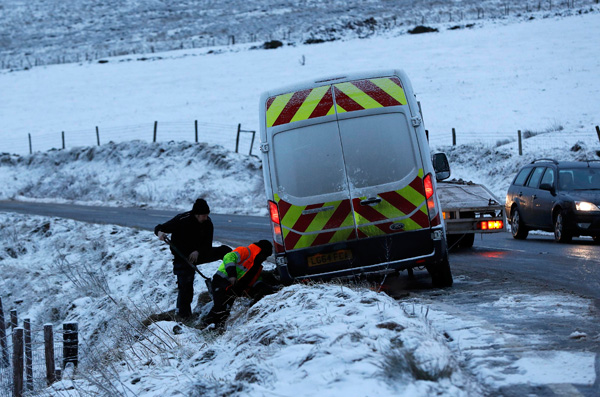 Britain braced for floods after heavy winds, snow