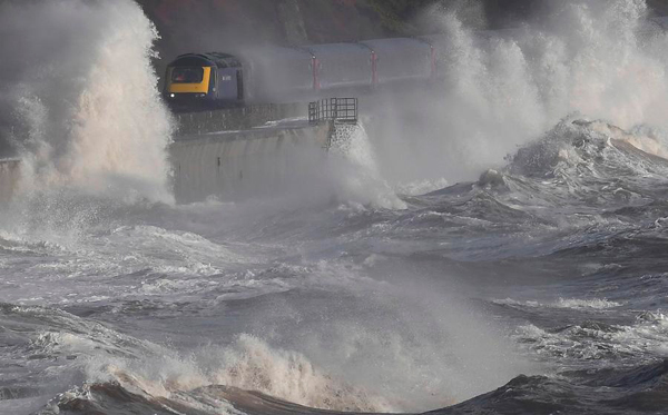 Trains plough through the waves on scenic UK line as storms approach