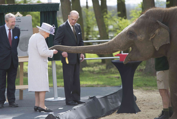 Queen Elizabeth II plays with her namesake baby elephant