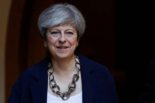 UK's Theresa May builds government despite uncertain support