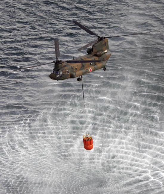 Helicopters dump water to cool reactor